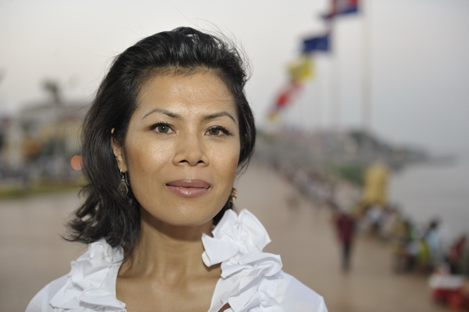 Theary Seng along the river in front of Royal Palace (photo by Roland Neveu, Dec. 2009)